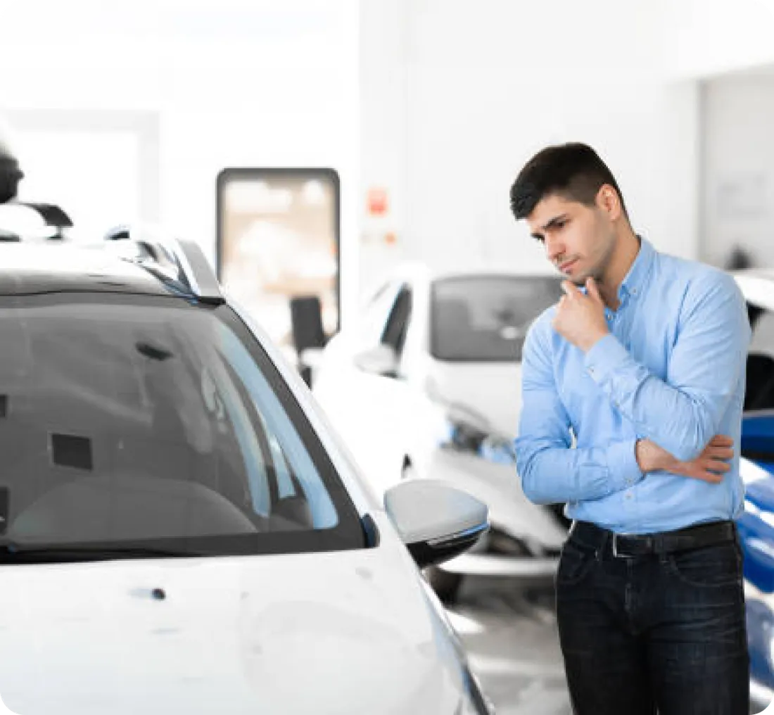 A customer inspecting a car on the Winston lot